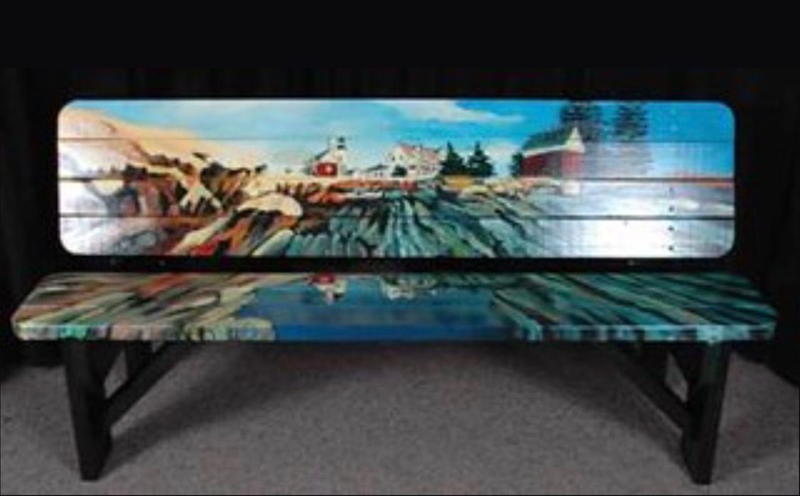 Hand painted street bench with a coastal lighthouse and red barn scene