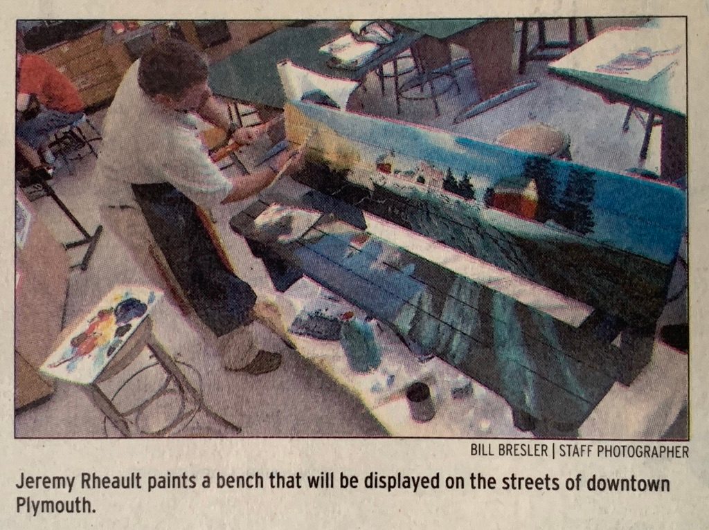 Jeremy Rheault painting a street bench