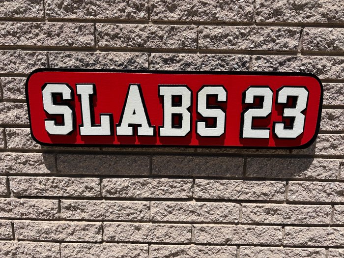 Slabs 23 custom business logo cutout on brick wall