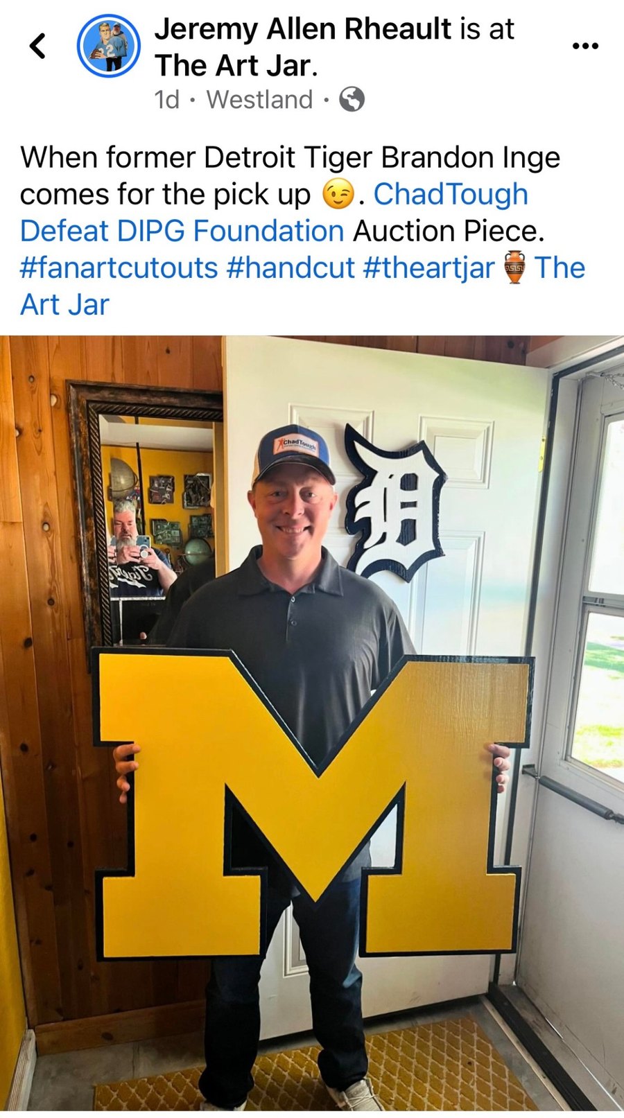 Facebook post: former Detroit Tiger Brandon Inge holding the custom maize Michigan block M he picked up for the Chad Tough Defeat DIPG Foundation auction, with a Tigers D on the door behind him
