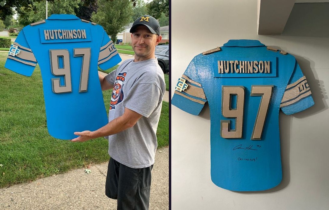 Custom Aidan Hutchinson tribute jersey cutout, held outdoors and signed on wall