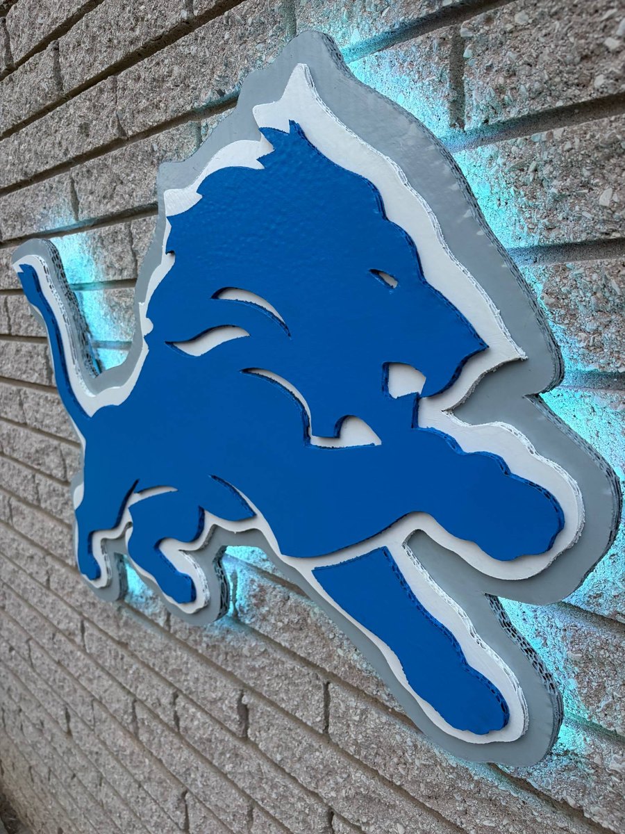 Custom layered silver Detroit Lions logo cutout with teal LED glow