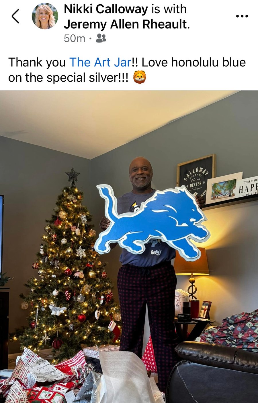 Customer holding a custom silver and honolulu blue Detroit Lions logo cutout, with a thank-you post