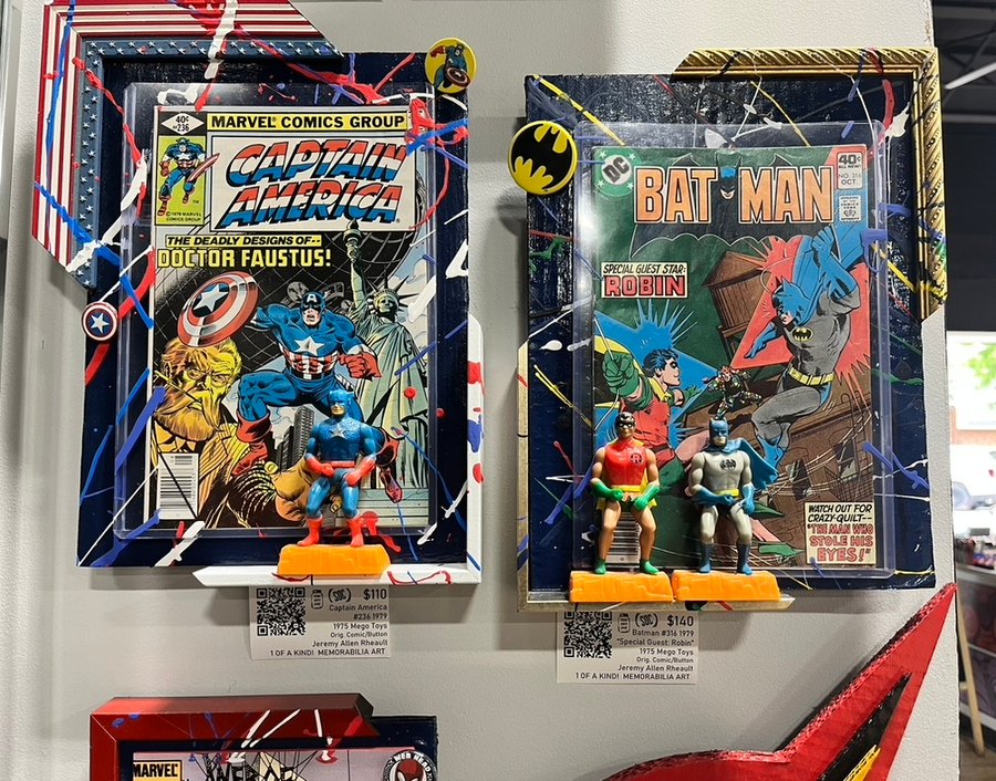Hand-embellished Captain America 236 and Batman 316 Special Guest Star Robin comics with vintage 1975 Mego Toys figures, on a shop wall
