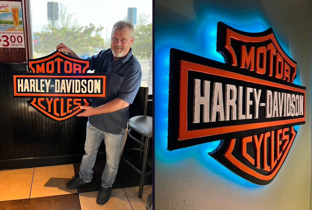 Custom Harley-Davidson Motor Cycles logo cutout in black, orange and cream: held by the customer, and the LED backlit version glowing blue on the wall