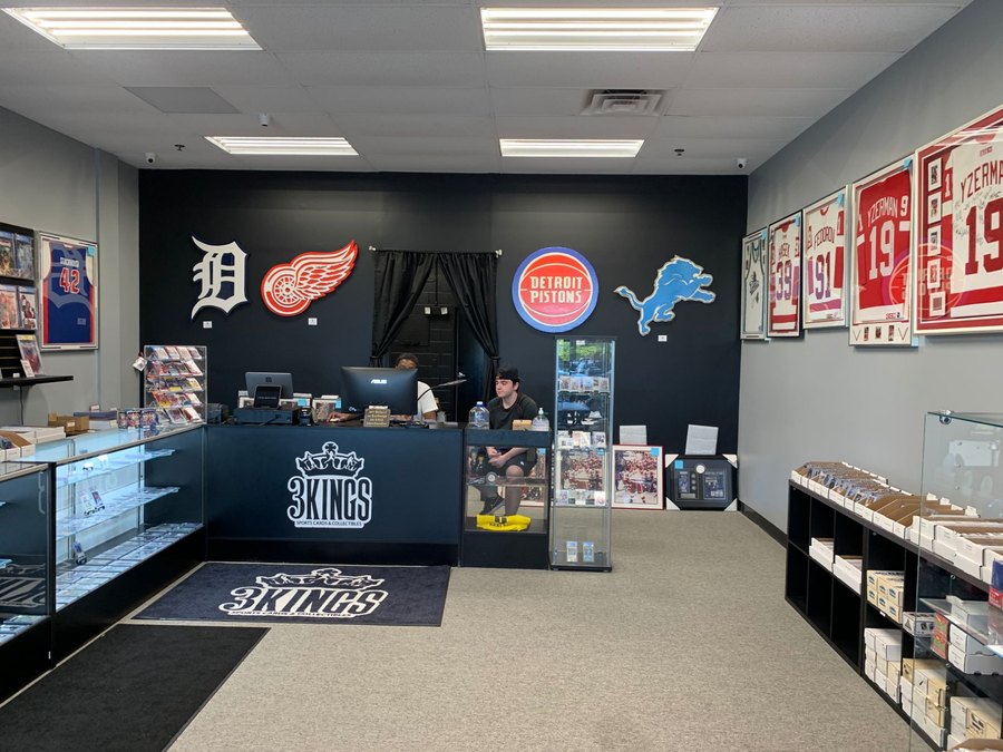 Custom Detroit Tigers, Red Wings, Pistons and Lions logo cutouts on the wall of a sports card shop