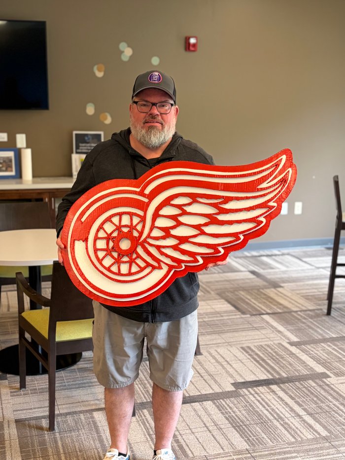 Custom Detroit Red Wings logo cutout, held by customer