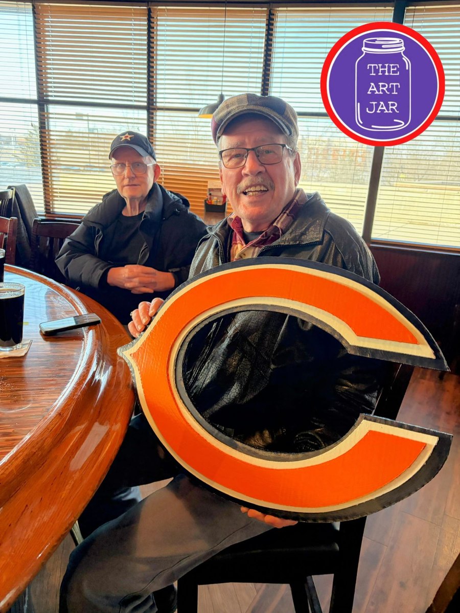 Customer holding a custom Chicago Bears C logo cutout