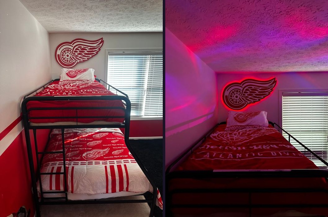 Custom Detroit Red Wings logo cutout above a bunk bed, daytime and LED-lit at night