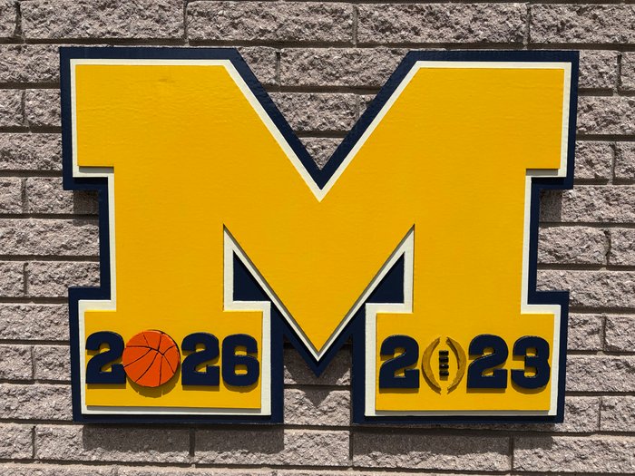 Custom Michigan block M cutout with 2026 and 2023 on brick wall