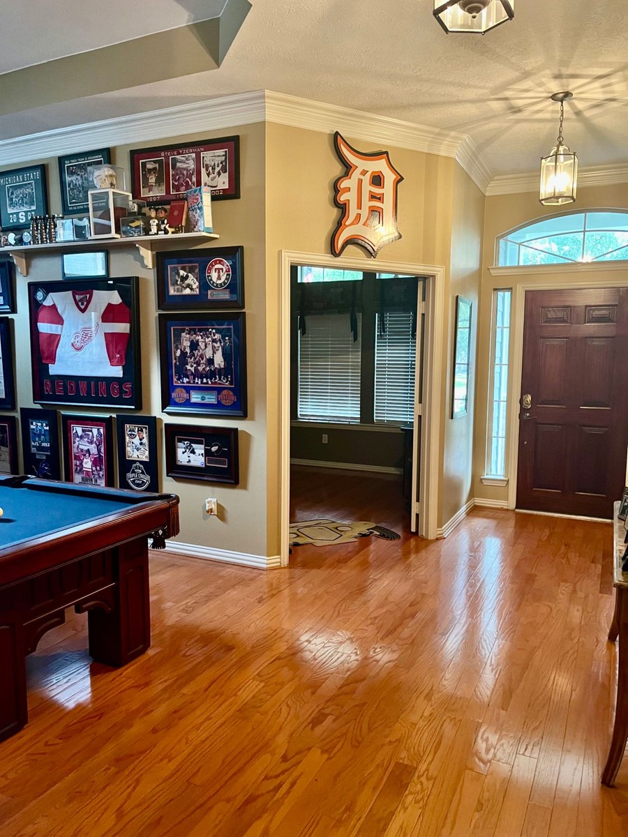 Custom Detroit Tigers Old English D cutout above a doorway in a sports memorabilia room