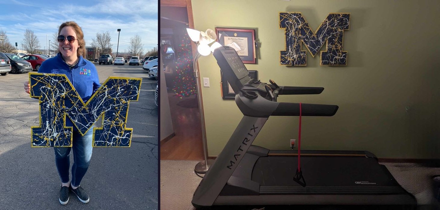 A customer holding the custom splatter-painted Michigan block M cutout in a parking lot, and the same M hung on a green wall in a home gym