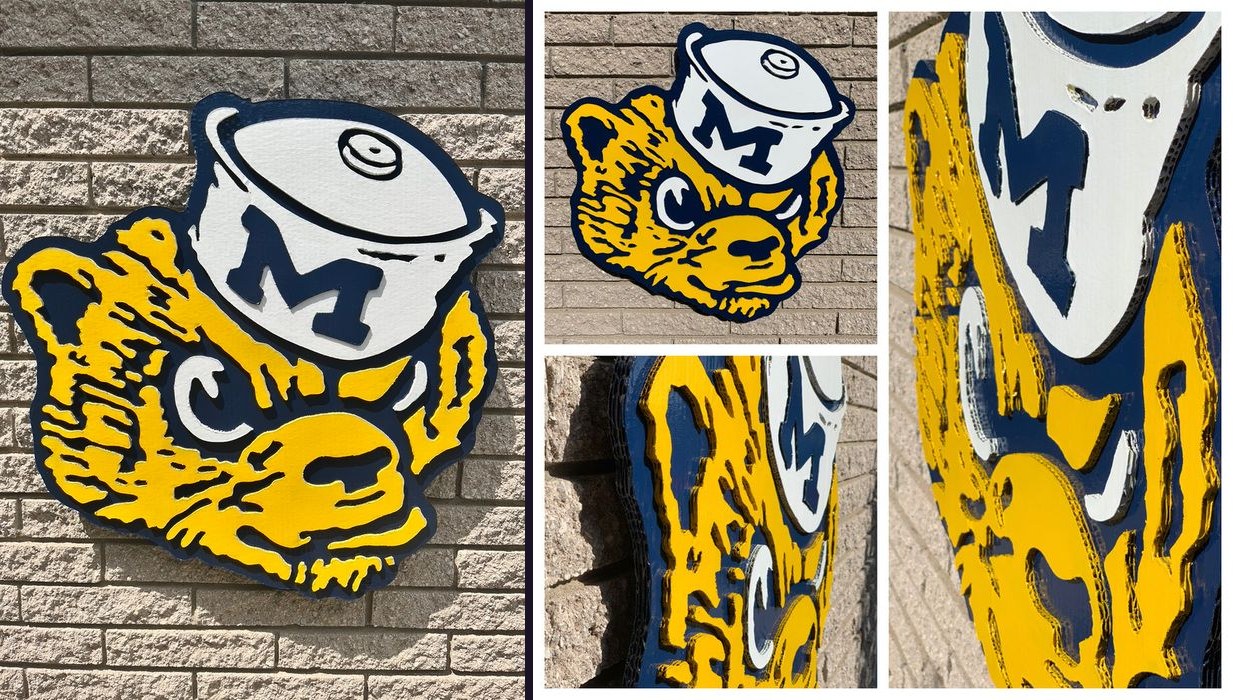 Custom vintage Michigan Wolverine cutout in maize and blue wearing a block M helmet, front on brick and in a collage of close-up angles