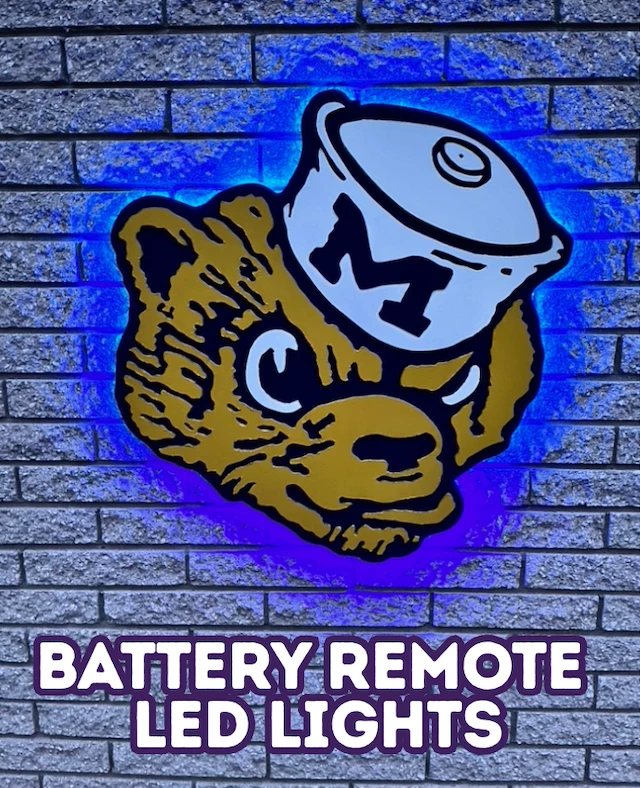 Custom Michigan Wolverine sign glowing blue with battery remote LED lights, on a brick wall