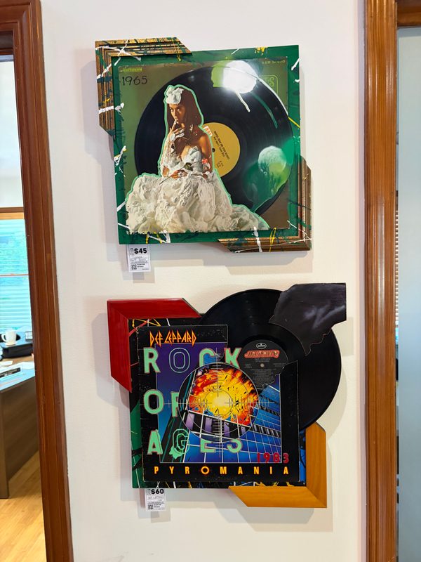 Two cut record art pieces: a bride album cover and Def Leppard Pyromania, with vinyl records