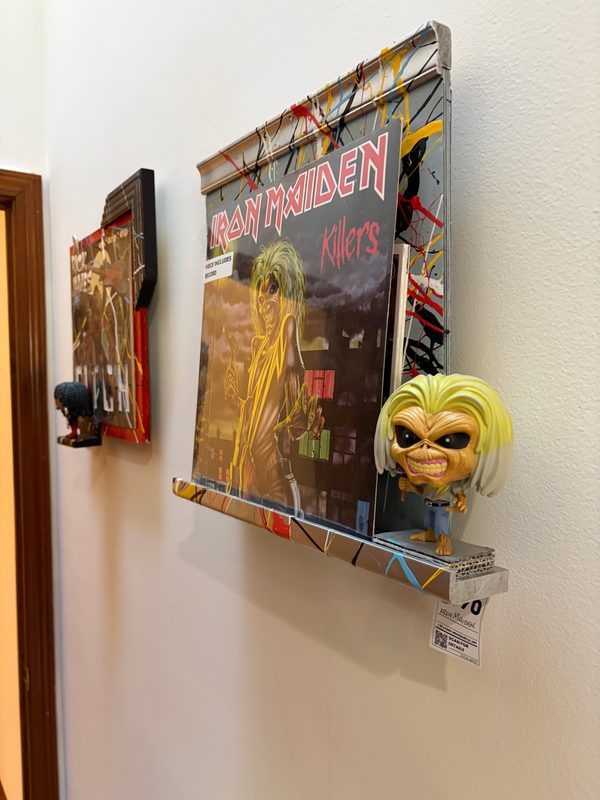 Iron Maiden Killers piece on the wall with other record art beside it
