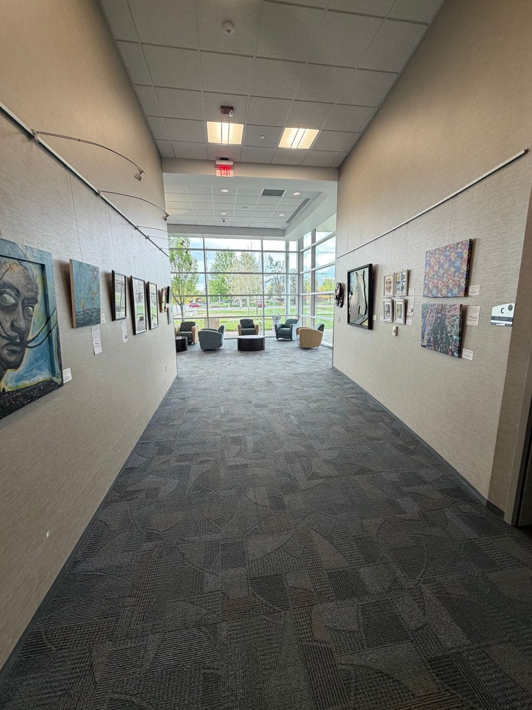 Long gallery hallway lined with framed artwork