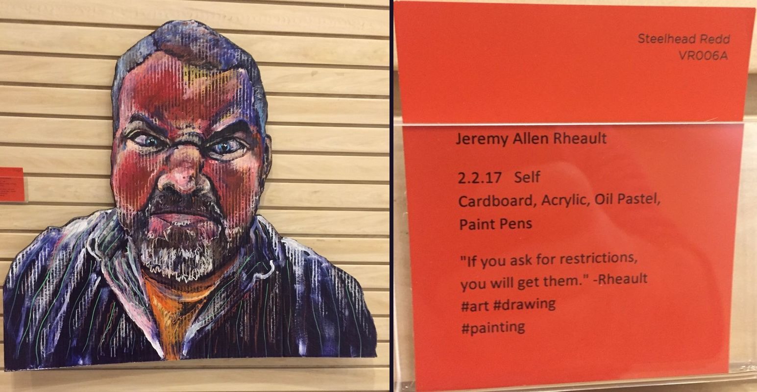 Painted cardboard self portrait next to its red paint sample gallery card