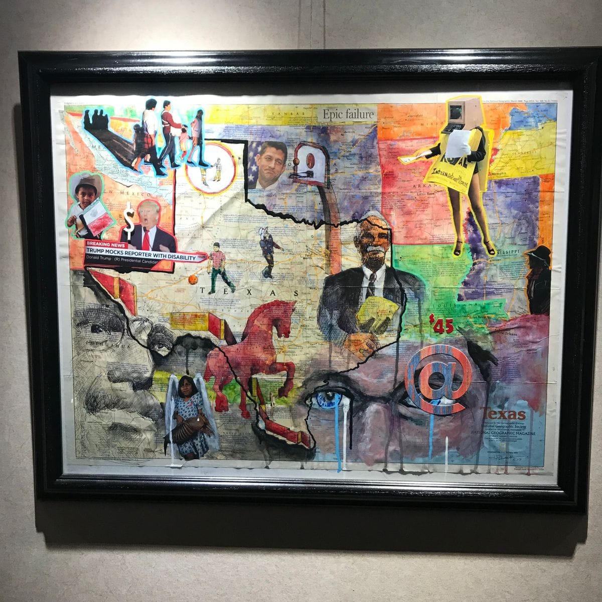 Mixed media collage by Jeremy Rheault on the wall at The Village Theater