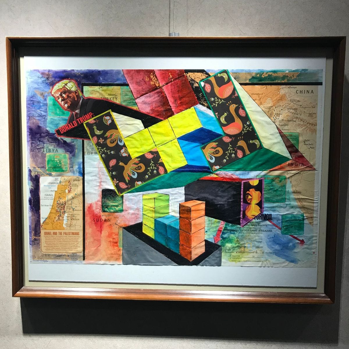Mixed media collage by Jeremy Rheault on the wall at The Village Theater