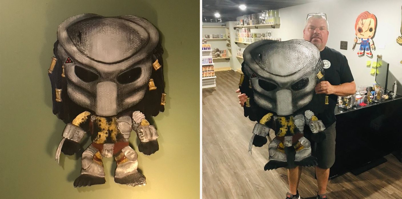 Hand-cut and hand-painted Funko Pop style Predator in a gray mask with dreadlocks and armor: on a green wall, and held in the Popgodz collectibles shop