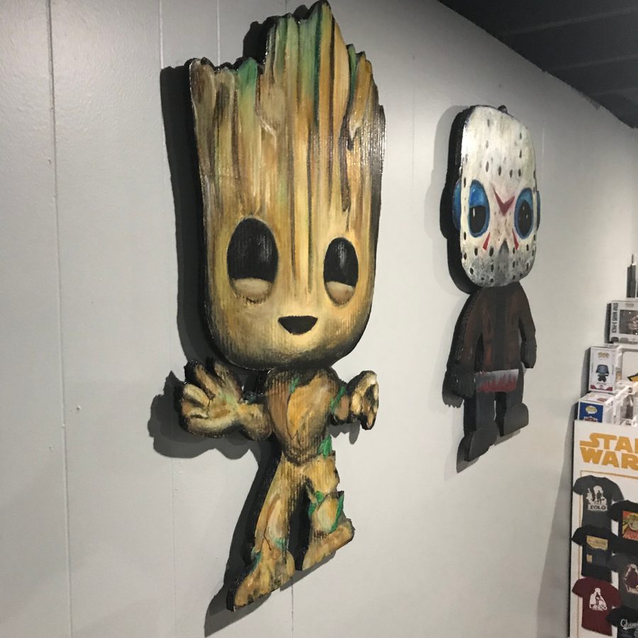 Close view of the Groot and Jason Voorhees cutouts on the wall with Star Wars boxes beside them