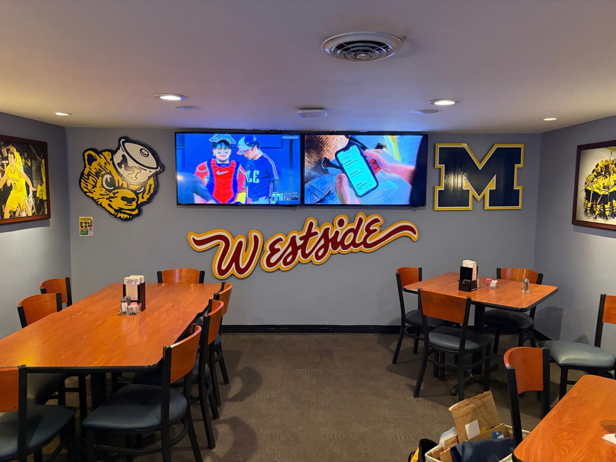 The Westside script under the TVs with a wolverine and a Michigan M above the long tables