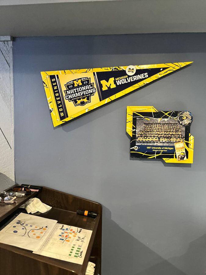 Hand-embellished Michigan National Champions pennant and a framed 1997 team photo on the blue wall