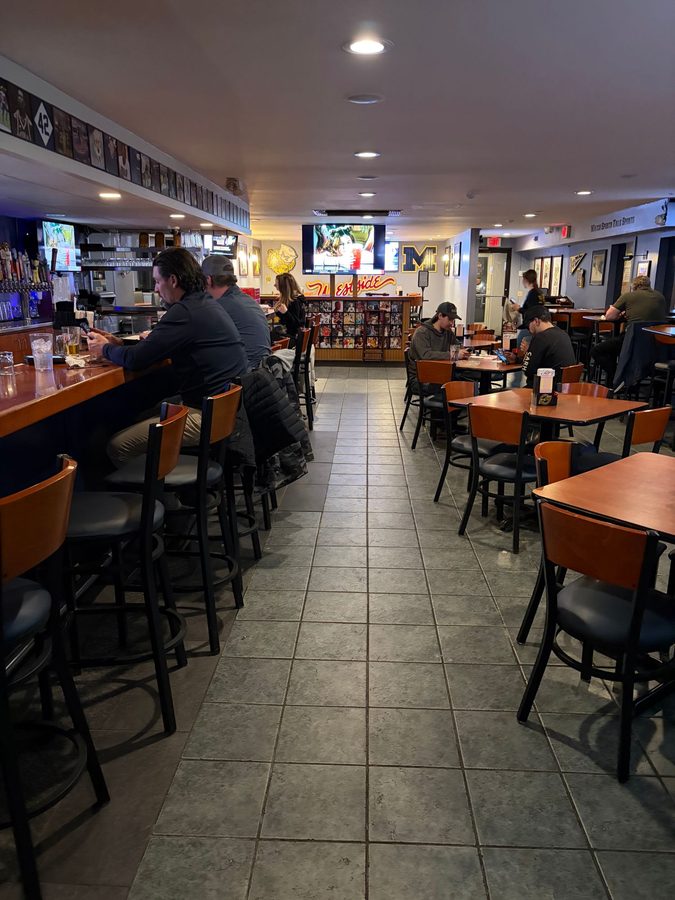 View down the bar and dining room to the Westside script, Michigan M and wolverine on the back wall