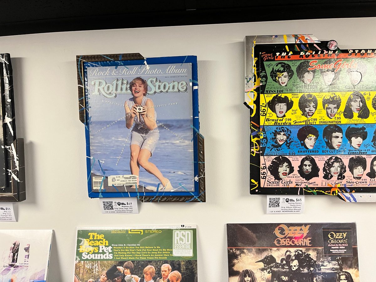 Hand-embellished Rolling Stone cover piece and a Some Girls album piece on the wall at Vinyl People Records