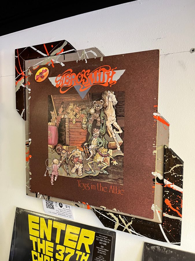 Hand-embellished Aerosmith Toys in the Attic album cover piece on the wall at Vinyl People Records